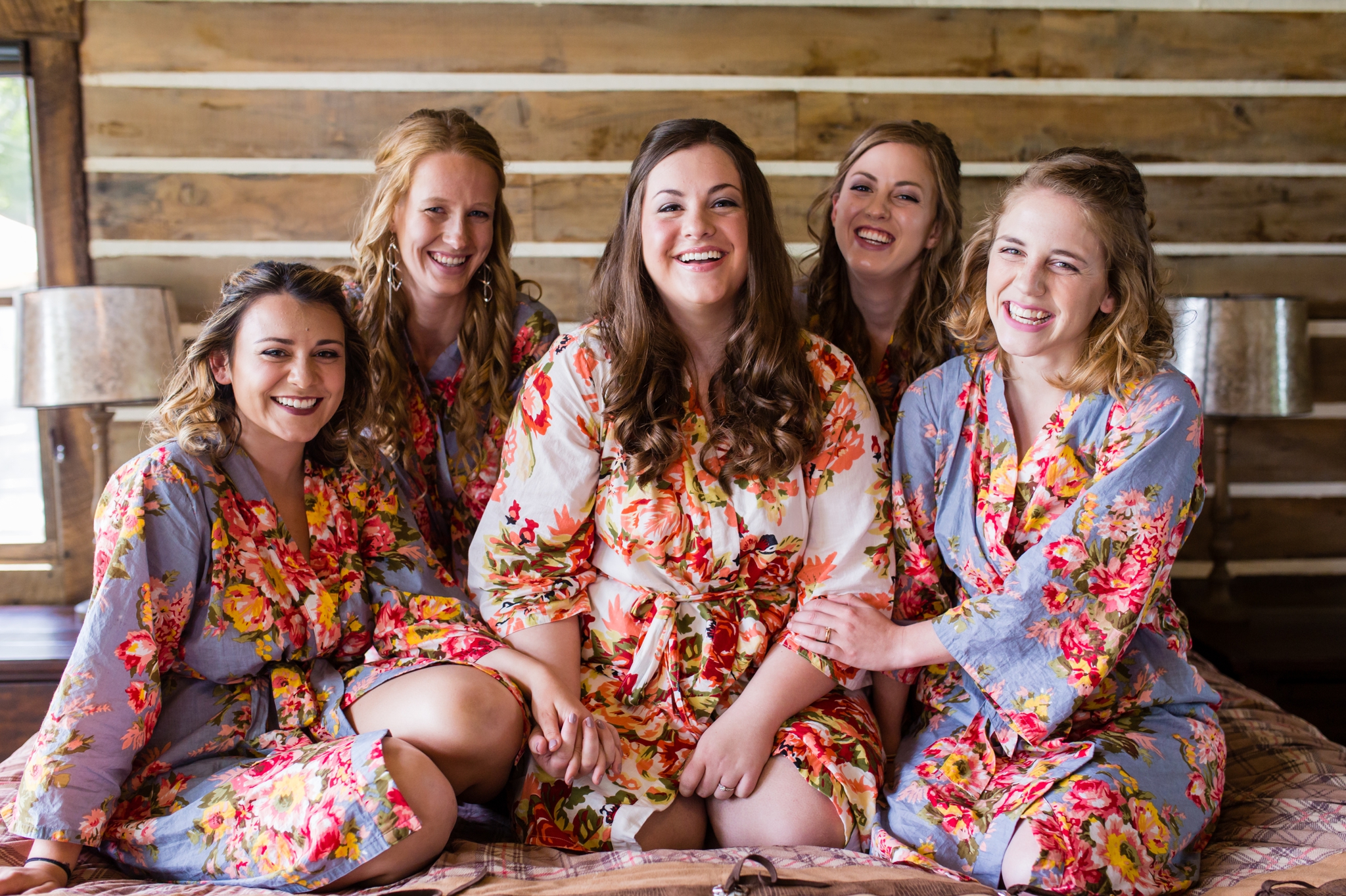 bridesmaids-on-bed-floral-robes