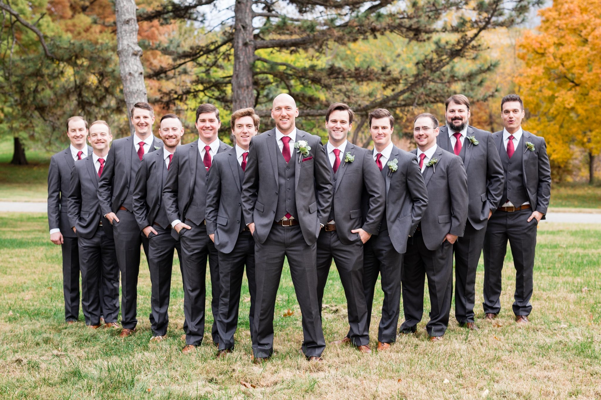 groomsmen in gray tuxes with burgandy ties