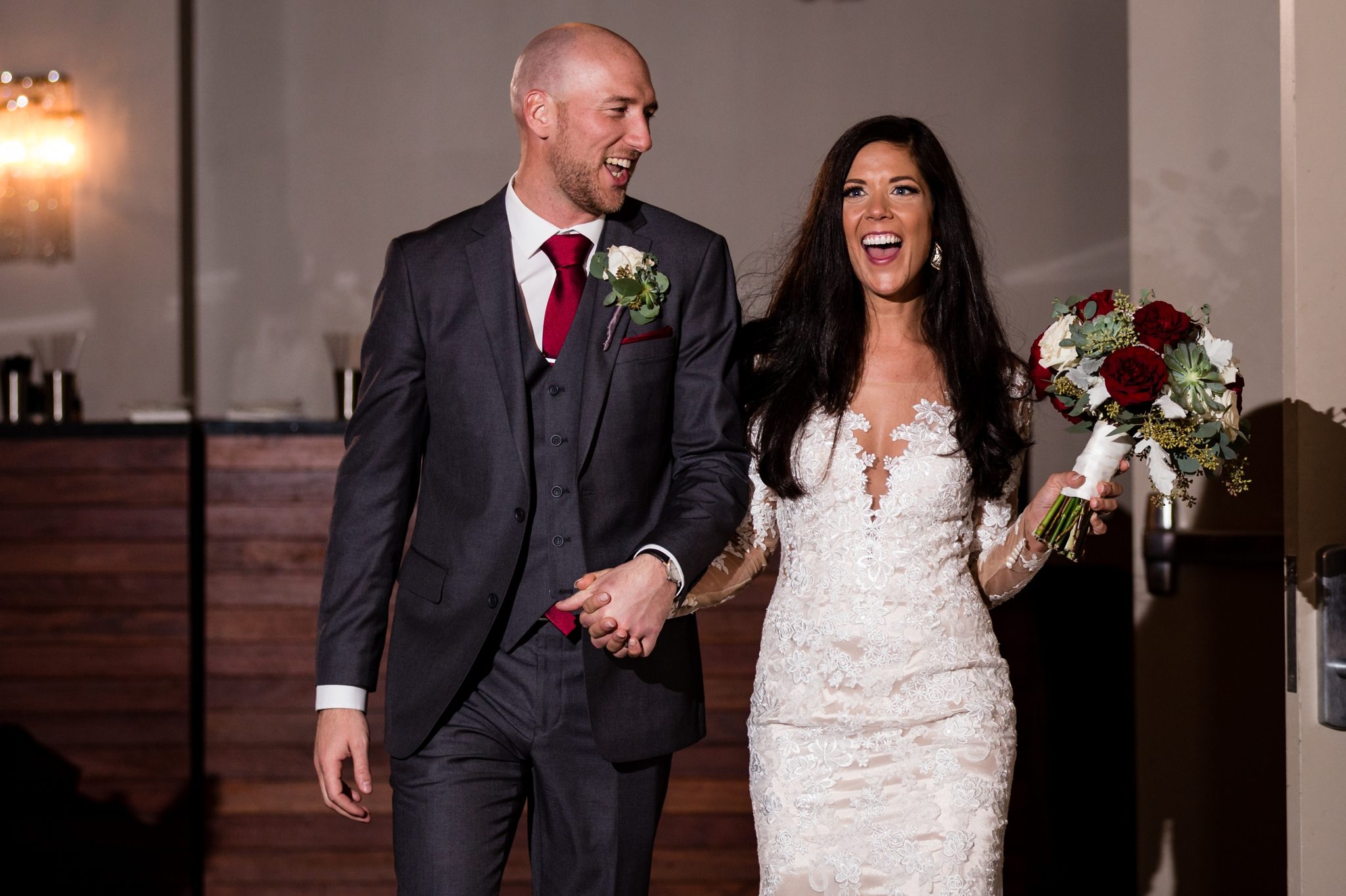 bride + groom smiling entrance into reception