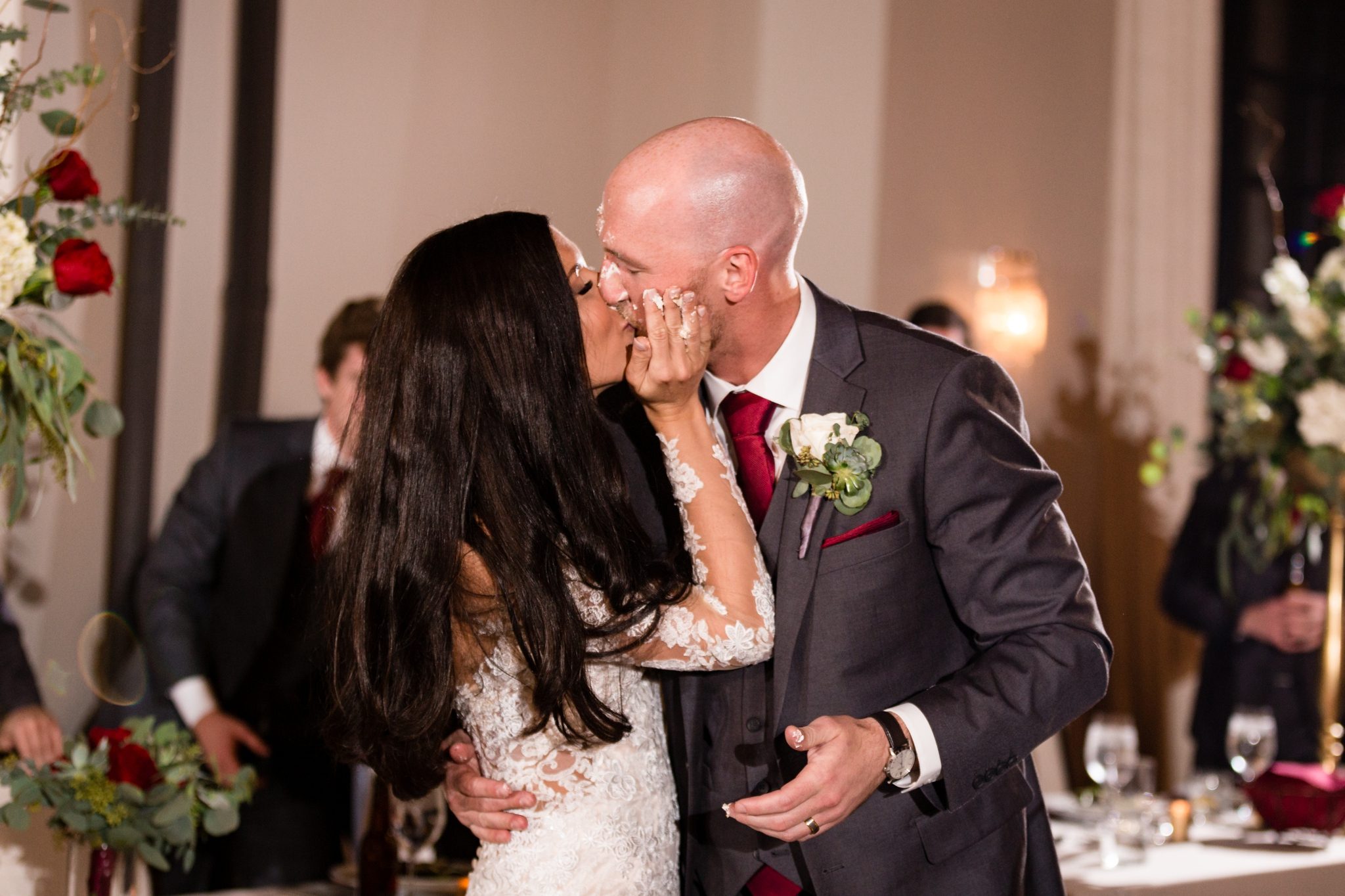 bride and groom kiss after cake smash
